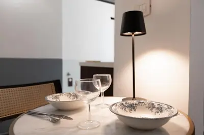 a table with two bowls and wine glasses on it at B&B Del Mercato in Rome