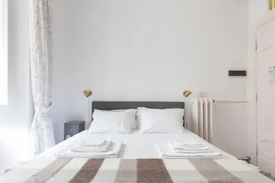 a white bed with white sheets and pillows at B&B Del Mercato in Rome