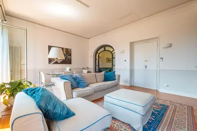a living room with two white couches and blue pillows at HT Borromini Penthouse in Rome