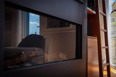 a television screen with a couch in a living room at HT Borromini Penthouse in Rome