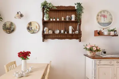 a dining room with a table and a shelf with plates at Stefano Soffici Domus Trastevere in Rome