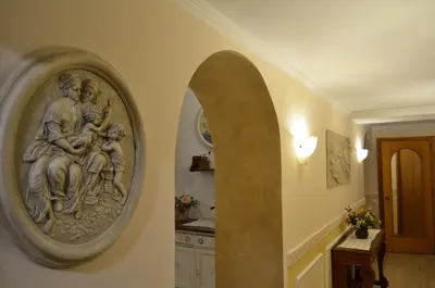 a wall with a sculpture of a woman holding a child at Stefano Soffici Domus Trastevere in Rome