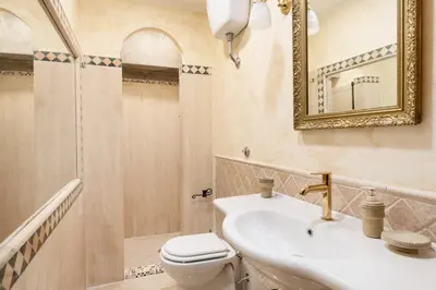 a bathroom with a sink and a toilet and a mirror at Stefano Soffici Domus Trastevere in Rome