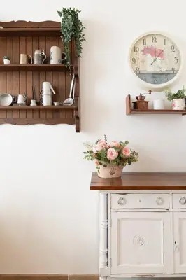 a room with a table with a clock and flowers at Stefano Soffici Domus Trastevere in Rome
