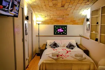 a bedroom with a bed with red flowers on it at Eleganza e Confort nel Cuore dei Parioli in Rome