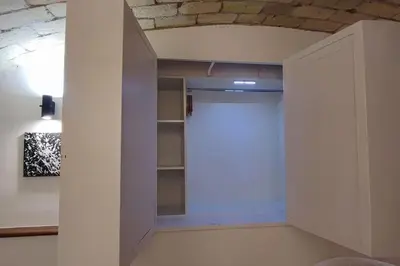 a closet with a white door in a room at Eleganza e Confort nel Cuore dei Parioli in Rome