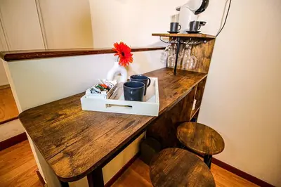 a wooden counter with a wooden table with a chair at Eleganza e Confort nel Cuore dei Parioli in Rome