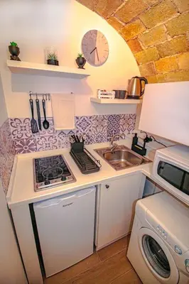 a small kitchen with a stove and a sink at Eleganza e Confort nel Cuore dei Parioli in Rome