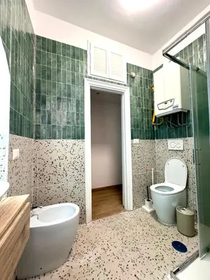 a bathroom with a tub and a toilet and a sink at Trastevere Elite 