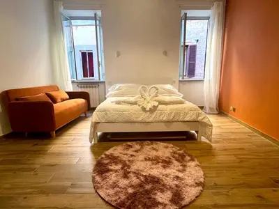 a bedroom with a bed with a bow on it at Trastevere Elite 