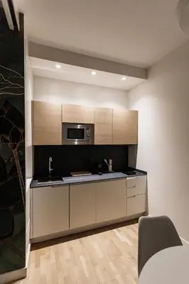 a kitchen with a sink and a microwave at Sant'Andrea Apartment in Rome