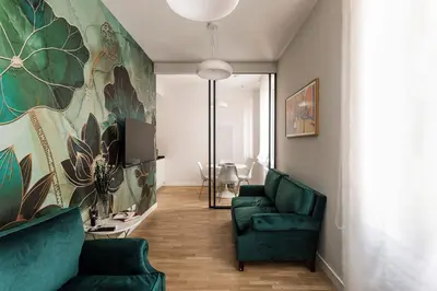 a living room with two green chairs and a couch at Sant'Andrea Apartment in Rome