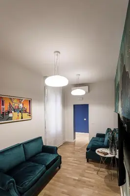 a living room with a green couch and a table at Sant'Andrea Apartment in Rome
