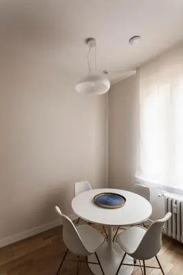 a white dining room with a white table and chairs at Sant'Andrea Apartment in Rome