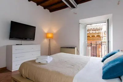 a bedroom with a bed and a tv and a window at PANTHEON LARGE APARTMENT IN THE HEART OF ROME s in Rome