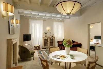 a living room with a white table and chairs at Daplace - Camelia Apartment in Rome