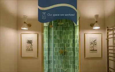 a bathroom with a shower with green tiles at Daplace - Camelia Apartment in Rome