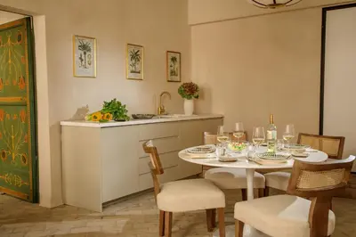 a kitchen and dining room with a table and chairs at Daplace - Camelia Apartment in Rome