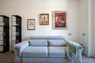 a living room with a blue couch and pictures on the wall at Sky Luxury in Rome