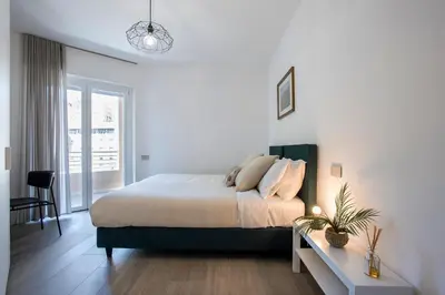 a white bedroom with a bed and a table at Sky Luxury in Rome