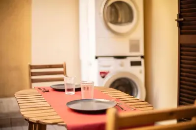a table with two plates and a washing machine at Casa Broccoletti in Rome