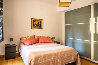 a bedroom with a bed with two red pillows at Casa Broccoletti in Rome