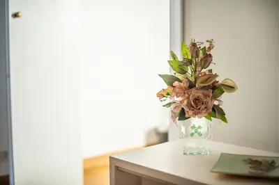 a vase filled with flowers on top of a table at Casa Broccoletti in Rome