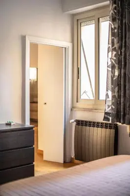 a bedroom with a bed and a window and a dresser at Casa Broccoletti in Rome