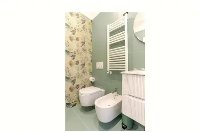 a bathroom with a white toilet and a sink at Lux Vaticana Suite in Rome