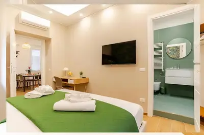 a bedroom with a bed with two towels on it at Lux Vaticana Suite in Rome
