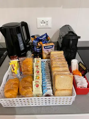 a tray of bread and other food on a counter at Lux Vaticana Suite in Rome