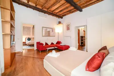a living room with a white couch and red furniture at PANTHEON 2 - LARGE APARTMENT IN THE HEARTH OF ROME a in Rome