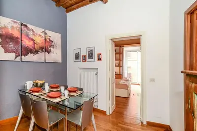 a dining room with a glass table and chairs at PANTHEON 2 - LARGE APARTMENT IN THE HEARTH OF ROME a in Rome