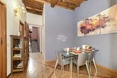 a dining room with a glass table and chairs at PANTHEON 2 - LARGE APARTMENT IN THE HEARTH OF ROME a in Rome