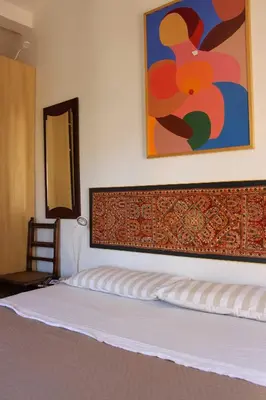 a bedroom with a bed with a painting on the wall at Casa Argia in Rome