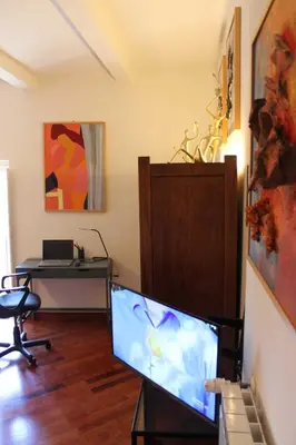 an office with a desk with a computer and a monitor at Casa Argia in Rome