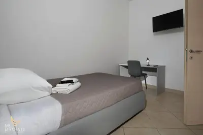 a bedroom with a bed with a desk and a chair at Garden and Relax in Rome