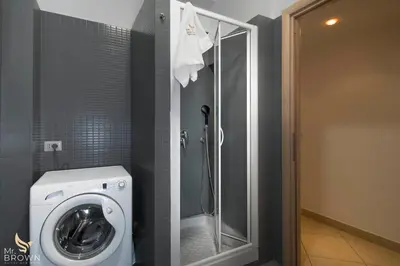 a bathroom with a washing machine and a shower at Garden and Relax in Rome