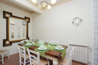 a dining room with a table and chairs at Apartment Marrucini in Rome