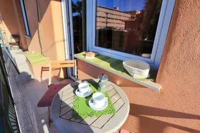 a table with cups and saucers on a window at Apartment Marrucini in Rome