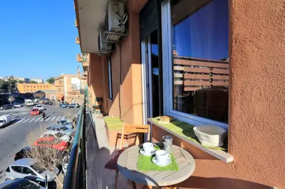 a balcony with a table and a view of a street at Apartment Marrucini in Rome