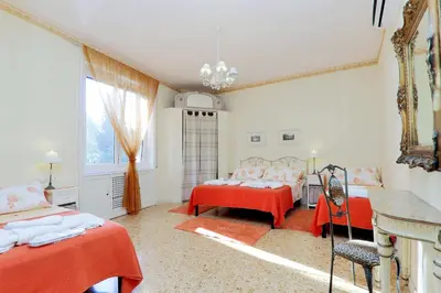a bedroom with two beds and a window at Apartment Marrucini in Rome