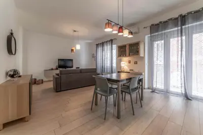 a living room with a table and chairs and a couch at Holiday Home in Rome