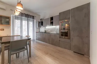 a kitchen with a wooden table and a dining room at Holiday Home in Rome