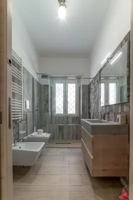 a bathroom with two sinks and a tub and a toilet at Holiday Home in Rome