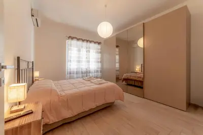 a bedroom with a large bed and a mirror at Holiday Home in Rome