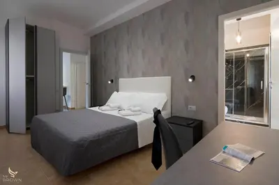a bedroom with a bed and a desk with a table at San Paolo Superior Room in Rome