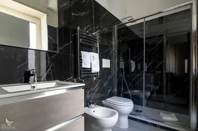 a bathroom with a toilet and a sink and a shower at San Paolo Superior Room in Rome