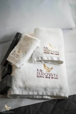 a pile of towels sitting on top of a bed at San Paolo Superior Room in Rome