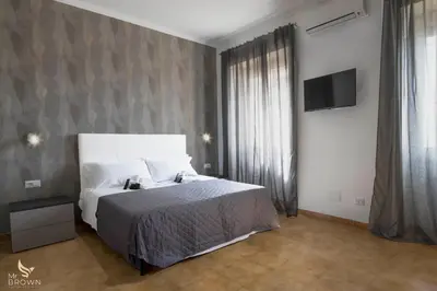 a bedroom with a bed and a tv on a wall at San Paolo Superior Room in Rome